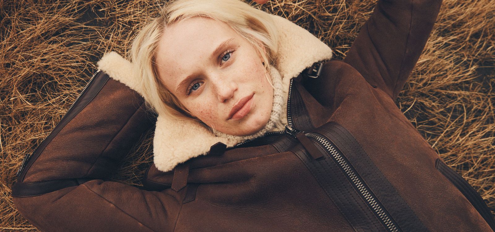 Female Model wearing the Belstaff Launch Jacket in Saddle Brown/Cord with the Fenn Rollneck Jumper in Sand.